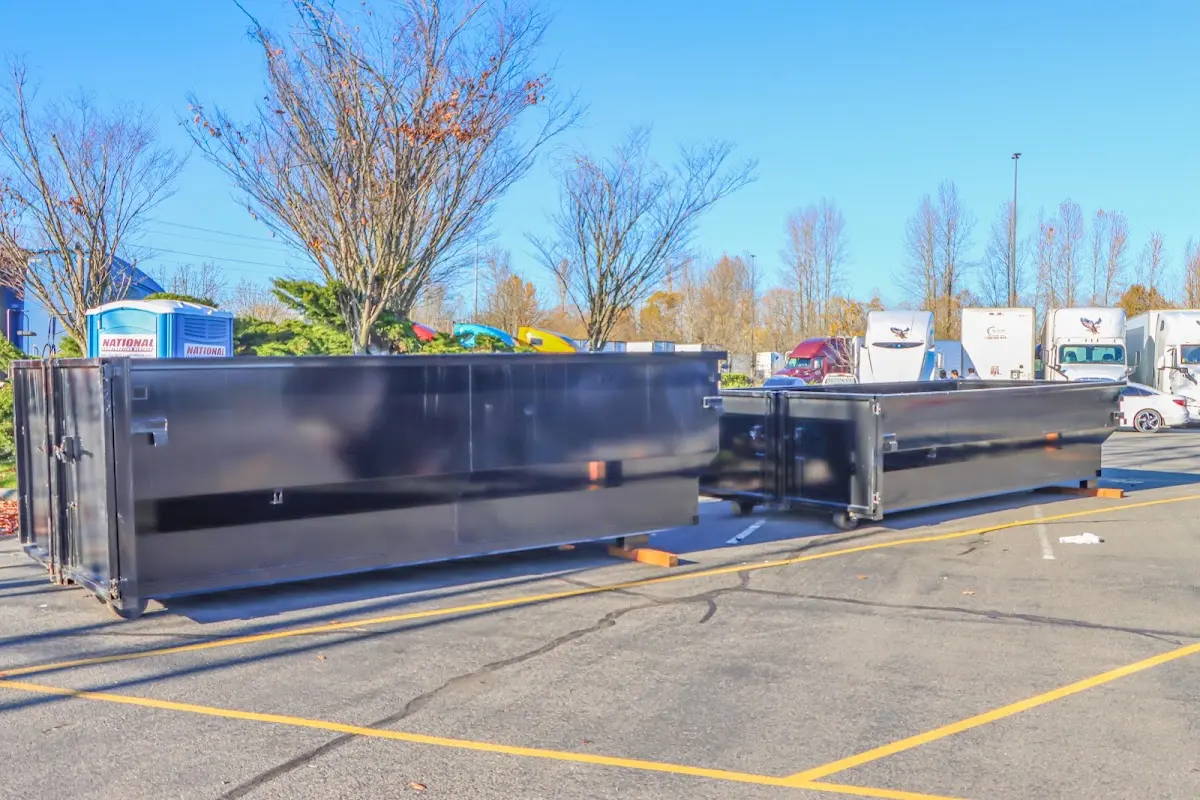 Professional dumpster rental service with roll-off container on residential driveway in Stafford